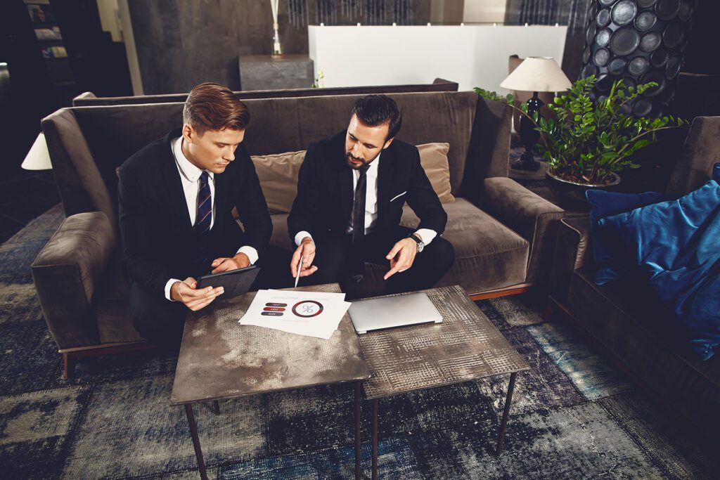 Two business men reviewing data in a hotel lounge