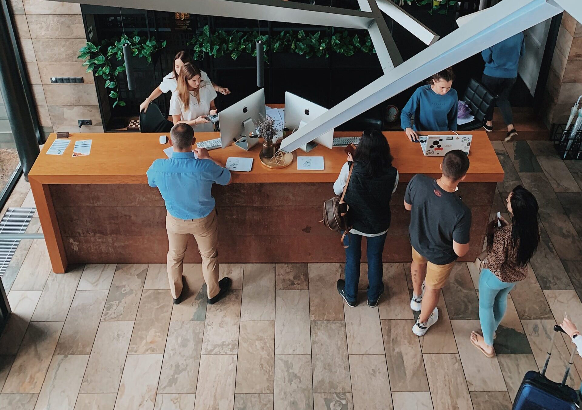 Guests checking into a modern hotel that is protected by property damage insurance.